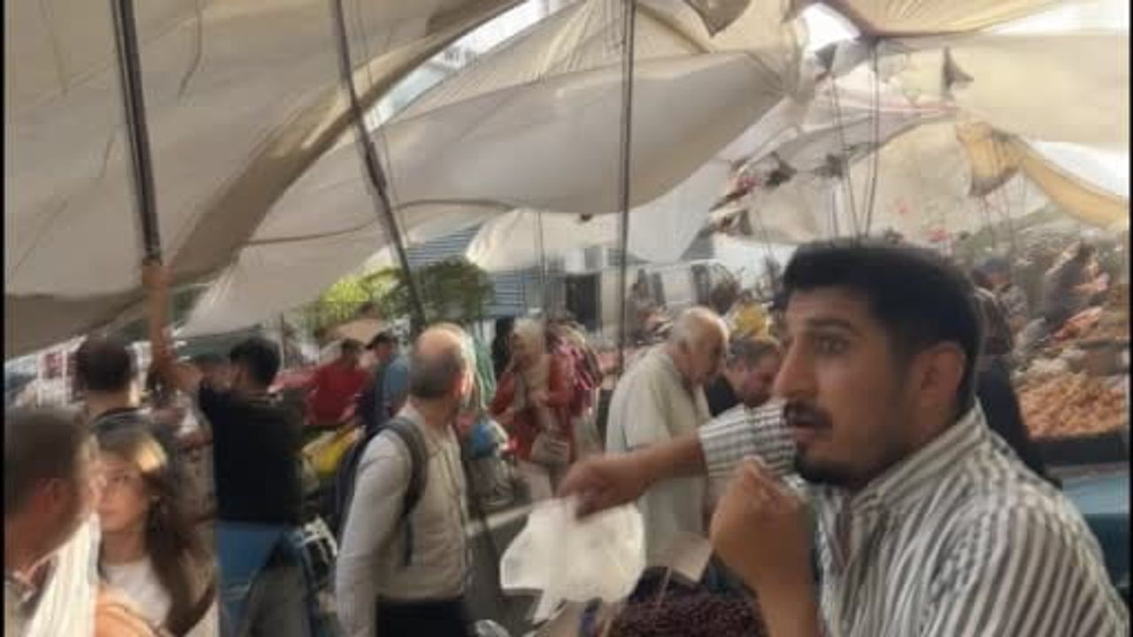 Kuvvetli rüzgarda pazarcı branda direğini bırakmadı, metrelerce havaya yükseldi