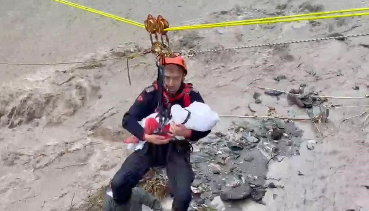 HALATA ASILI HALDE KARŞI GEÇTİĞİ ESNADA KUCAĞINDAKİ BEBEK UYANMASIN DİYE PIŞPIŞLAYARAK KARŞIYA...