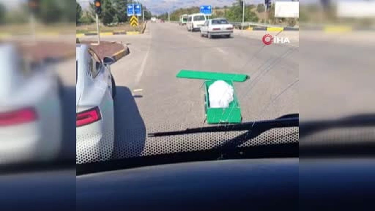 Seyir halindeki cenaze aracından içinde cenaze bulunan tabut yola düştü